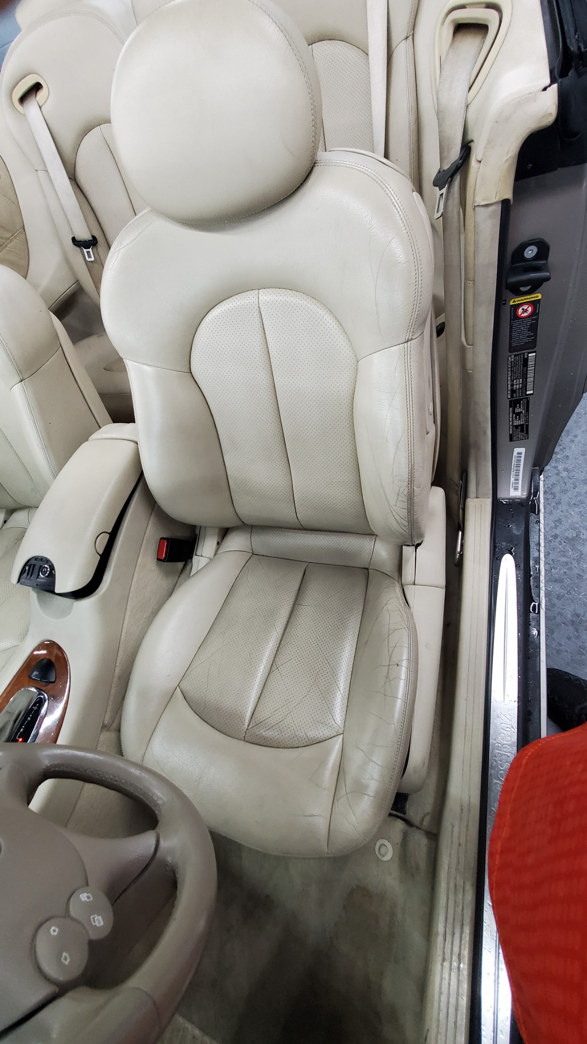 Light leather front seat before restoration